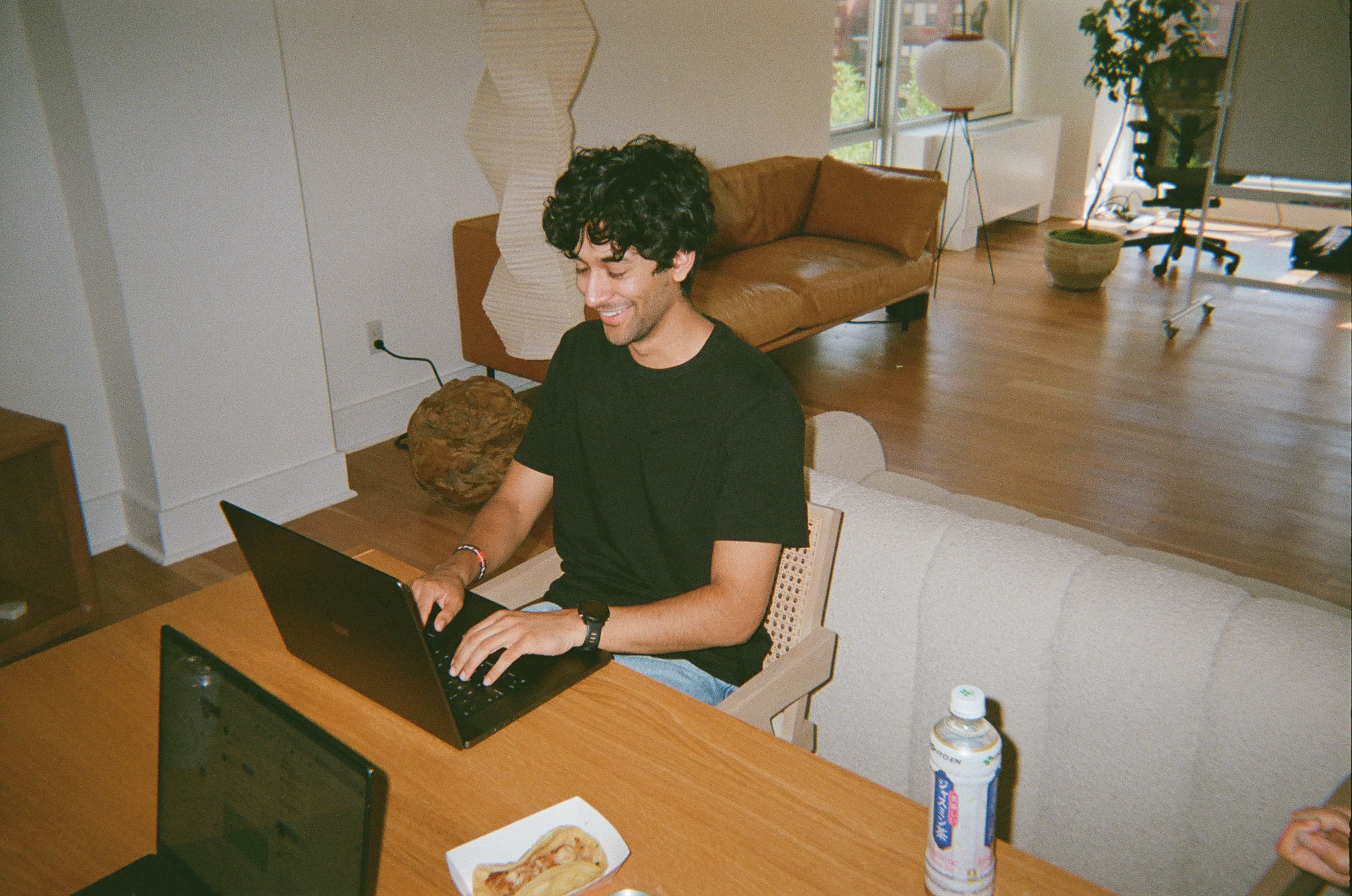 A teammate working at a laptop in the Oasis office